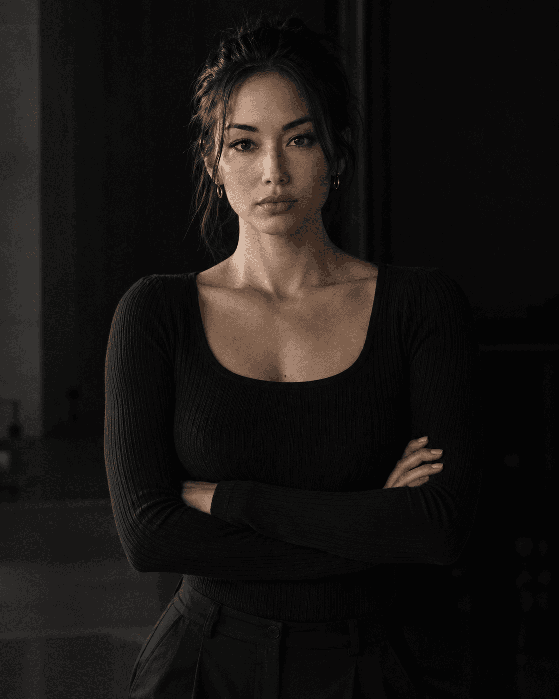 Yuki Tanaka-Brooks, three-quarter portrait on the floor they coach, arms folded